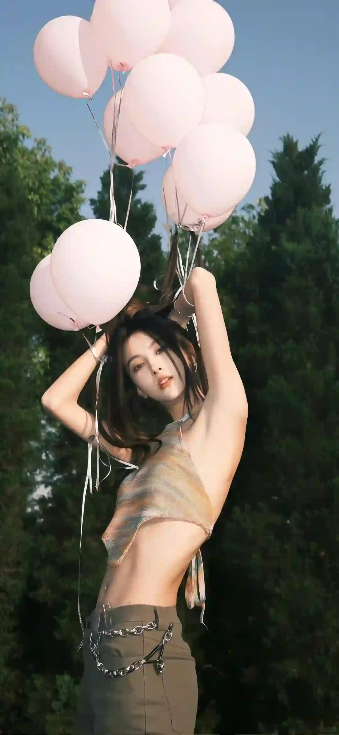 手拿氢气球的长发时尚美女 户外